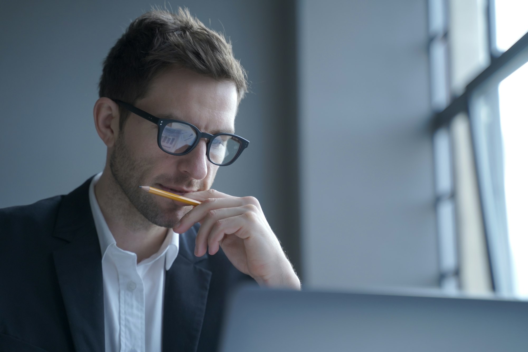 Serious german man executive dressed in formal clothes looking at laptop screen browsing internet